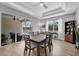 Well-lit dining room with modern light fixtures and a view of the outdoor pool at 8223 Haven Harbour Way, Bradenton, FL 34212