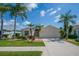 Lovely home with a well-manicured lawn, mature trees, and a paved driveway leading to a two-car garage at 8223 Haven Harbour Way, Bradenton, FL 34212