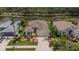 Beautifully landscaped single-Gathering home with mature trees, lush lawn, and a paved driveway and attached garage at 8223 Haven Harbour Way, Bradenton, FL 34212