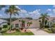 Inviting one-story home featuring lush landscaping, decorative plants, and a spacious driveway at 8223 Haven Harbour Way, Bradenton, FL 34212