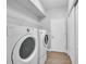 Well-organized laundry room with updated washer and dryer and shelf storage at 8223 Haven Harbour Way, Bradenton, FL 34212