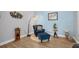 Cozy sitting room nook with a comfy armchair and ottoman with hardwood flooring at 8223 Haven Harbour Way, Bradenton, FL 34212