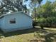 Spacious backyard featuring light blue siding and lush lawn at 8618 N Orangeview Ave, Tampa, FL 33617