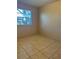 Bedroom with a window and tile flooring at 8618 N Orangeview Ave, Tampa, FL 33617