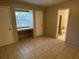 Bedroom with a window, tile flooring and access to the bathroom at 8618 N Orangeview Ave, Tampa, FL 33617