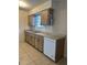 Practical kitchen featuring tile flooring, ample cabinet space, and essential appliances at 8618 N Orangeview Ave, Tampa, FL 33617