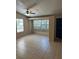 Bright living room with neutral tile flooring, ceiling fan and large window at 8618 N Orangeview Ave, Tampa, FL 33617
