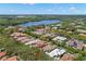 Aerial view showcasing a home's location within a community and proximity to a lake at 8708 Laurel N Dr, Pinellas Park, FL 33782
