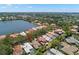 Aerial view of waterfront homes with lush landscaping and private pools nestled along a scenic lake at 8708 Laurel N Dr, Pinellas Park, FL 33782