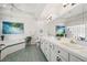 Spacious bathroom with dual sinks, large soaking tub, and decorative tile accents at 8708 Laurel N Dr, Pinellas Park, FL 33782