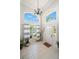 Bright foyer with high ceilings, tile flooring, and a modern chandelier at 8708 Laurel N Dr, Pinellas Park, FL 33782