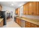 Well-lit kitchen featuring stainless steel appliances and abundant counter space at 8708 Laurel N Dr, Pinellas Park, FL 33782