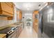 Well-lit kitchen featuring granite countertops, stainless steel appliances, and an eat-in dining area at 8708 Laurel N Dr, Pinellas Park, FL 33782
