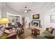 Spacious living room showcasing a fireplace, TV, and comfortable seating area at 8708 Laurel N Dr, Pinellas Park, FL 33782