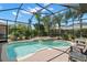 Captivating pool and spa enclosed within a screen, surrounded by lush landscaping at 8708 Laurel N Dr, Pinellas Park, FL 33782