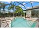 Sparkling screened pool and spa area with brick pavers and serene backyard view at 8708 Laurel N Dr, Pinellas Park, FL 33782