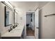 Modern bathroom features a double sink vanity with quartz countertops and sleek, dark fixtures at 909 E 28Th Ave, Tampa, FL 33605