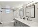 Bathroom featuring a double vanity, sleek fixtures, and a bright, modern design with storage at 909 E 28Th Ave, Tampa, FL 33605