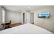 Bedroom showcasing a closet, desk and TV with an ensuite bathroom creating a functional and comfortable space at 909 E 28Th Ave, Tampa, FL 33605