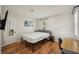Bedroom featuring wood-look floors, neutral walls, and a modern desk and bedframe at 909 E 28Th Ave, Tampa, FL 33605