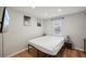 Bedroom featuring wood-look floors, neutral walls, and a modern desk and bedframe at 909 E 28Th Ave, Tampa, FL 33605
