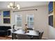 Open-concept dining area with a modern chandelier, neutral walls, and hardwood flooring at 909 E 28Th Ave, Tampa, FL 33605