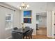 Charming dining room with wood floors and stylish chandelier, adjacent to kitchen at 909 E 28Th Ave, Tampa, FL 33605