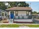 Charming single-story home with a welcoming front porch and a vibrant blue door at 909 E 28Th Ave, Tampa, FL 33605
