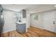 Bright kitchen features gray cabinets, white subway tile backsplash, and wood-look floors at 909 E 28Th Ave, Tampa, FL 33605