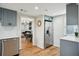 Modern kitchen with stainless steel appliances and an open view into the dining and living areas at 909 E 28Th Ave, Tampa, FL 33605
