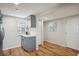 Bright kitchen features gray cabinets, white subway tile backsplash, and wood-look floors at 909 E 28Th Ave, Tampa, FL 33605