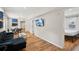 Spacious living room with hardwood flooring that opens to the dining area and bedroom at 909 E 28Th Ave, Tampa, FL 33605