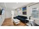 Bright living room with sleek furniture, wood floors, and modern artistic decor at 909 E 28Th Ave, Tampa, FL 33605