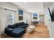 Open-concept living room boasts hardwood floors, modern art, and a contemporary aesthetic at 909 E 28Th Ave, Tampa, FL 33605