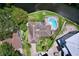 Aerial view of a house with a backyard pool, surrounded by well-maintained lawn and waterfront views at 9631 Oak Ne St, St Petersburg, FL 33702