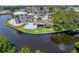 Aerial view of a waterfront home featuring a pool and adjacent vacant lot at 9631 Oak Ne St, St Petersburg, FL 33702
