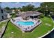 Aerial shot of the property featuring a heart-shaped pool and fenced yard at 9631 Oak Ne St, St Petersburg, FL 33702