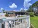 Backyard features brick pavers, green lawn and white fence surrounding the patio at 9631 Oak Ne St, St Petersburg, FL 33702