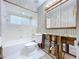 Bathroom featuring a vanity, mirror, tub, shower, and tiled floor at 9631 Oak Ne St, St Petersburg, FL 33702