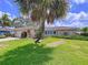 Charming single-story home featuring lush landscaping and a well-manicured lawn at 9631 Oak Ne St, St Petersburg, FL 33702
