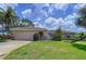 Inviting home with a well-kept lawn, mature trees, and a two-car garage at 9631 Oak Ne St, St Petersburg, FL 33702