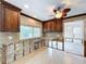 Kitchen showcasing wood cabinets, tile flooring, and bright natural light from window at 9631 Oak Ne St, St Petersburg, FL 33702