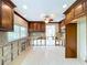 Kitchen with custom wood cabinets, tile backsplash, and window with bright view at 9631 Oak Ne St, St Petersburg, FL 33702