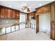Kitchen featuring wood cabinets, tile backsplash, and modern lighting fixtures at 9631 Oak Ne St, St Petersburg, FL 33702