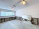 View of a living room needing renovation with a ceiling fan, large window, and exposed walls at 9631 Oak Ne St, St Petersburg, FL 33702