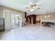 Open living space with tile flooring, adjacent kitchen, and sliding glass doors at 9631 Oak Ne St, St Petersburg, FL 33702
