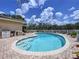 Backyard showcases a kidney-shaped pool with brick pavers and clear blue skies overhead at 9631 Oak Ne St, St Petersburg, FL 33702