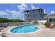 Backyard includes a kidney-shaped pool, brick pavers, and a partially completed building nearby at 9631 Oak Ne St, St Petersburg, FL 33702