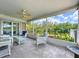 Enclosed porch with outdoor furniture, and scenic waterfront views at 9631 Oak Ne St, St Petersburg, FL 33702