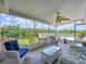 Screened porch with comfortable seating, overlooking a tranquil water view at 9631 Oak Ne St, St Petersburg, FL 33702